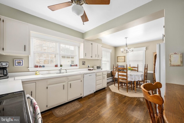 kitchen with light countertops, a sink, dark wood-style floors, dishwasher, and white cabinets