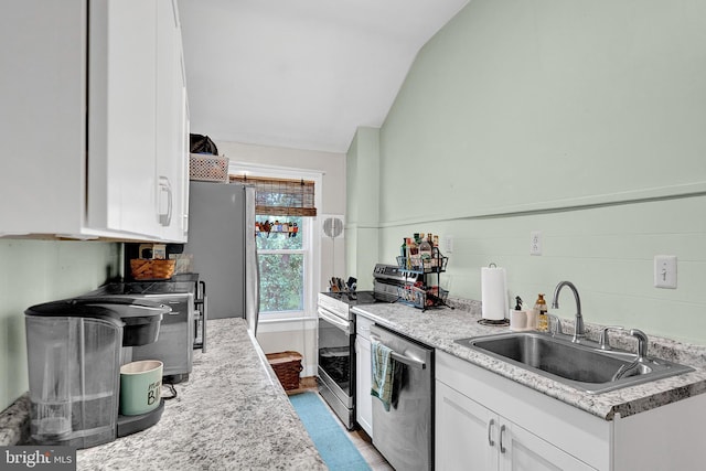 24 Montague Ave, Ewing, NJ 08628 - kitchen featuring appliances with stainless steel finishes, a sink, white cabinetry, wood finished floors, and lofted ceiling