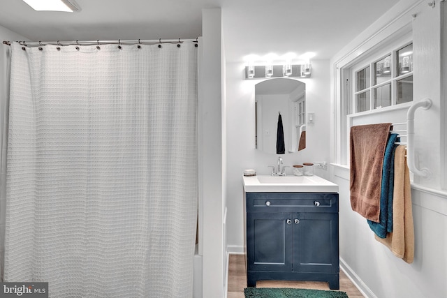24 Montague Ave, Ewing, NJ 08628 - bathroom with vanity, baseboards, a shower with shower curtain, and wood finished floors