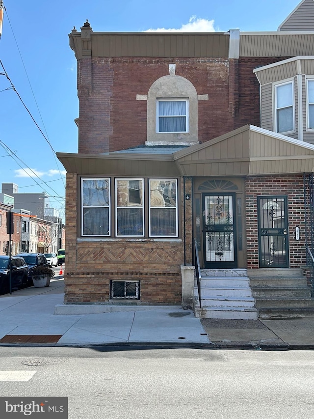 view of front of house featuring brick siding