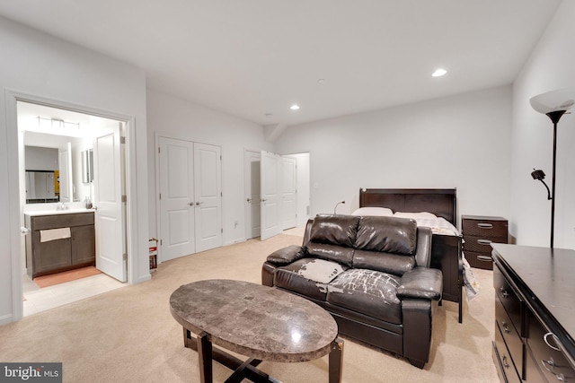 bedroom featuring light colored carpet, recessed lighting, connected bathroom, and a sink