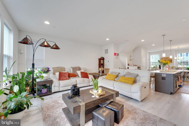 living area featuring light wood-type flooring and recessed lighting
