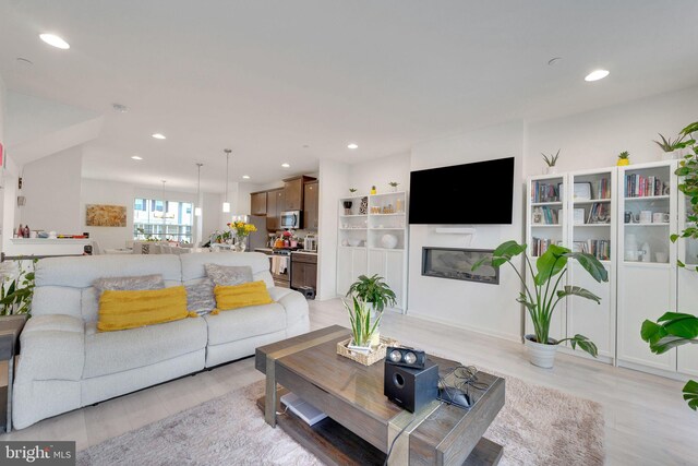 living room with recessed lighting and light wood finished floors