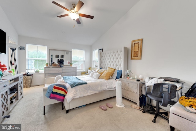 bedroom featuring lofted ceiling, light colored carpet, and ceiling fan