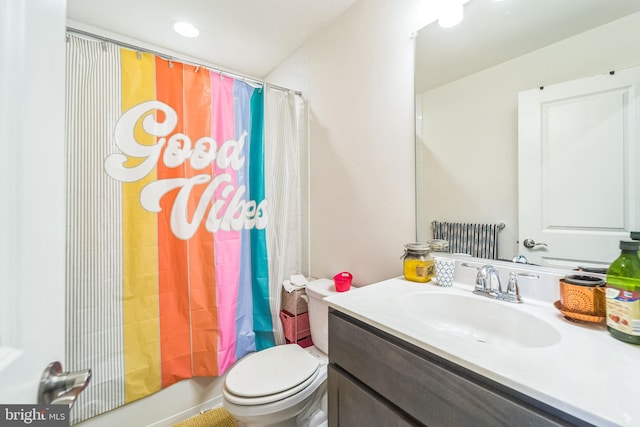 bathroom with vanity, toilet, and shower / tub combo with curtain