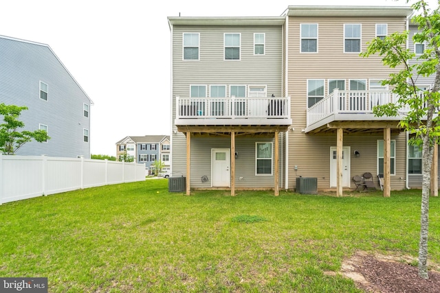 rear view of house with cooling unit and a wooden deck