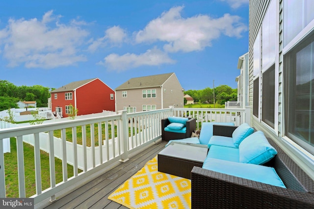 deck with an outdoor living space and a residential view