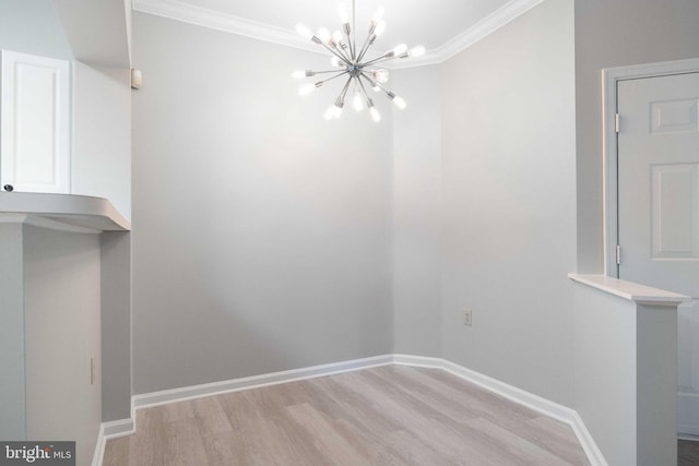 unfurnished dining area featuring crown molding, baseboards, light wood finished floors, and a chandelier