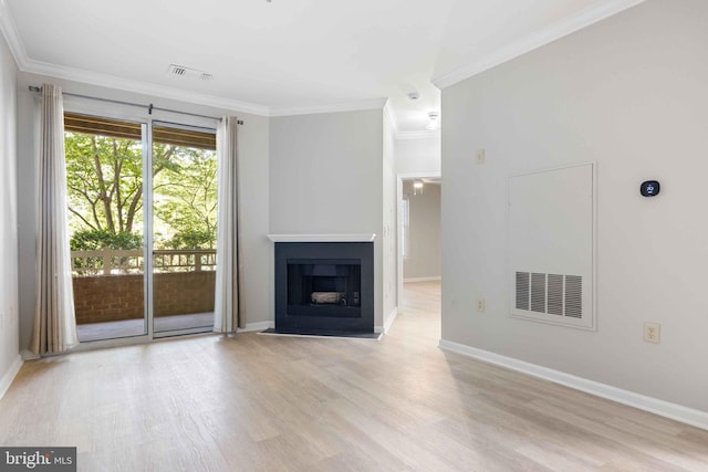unfurnished living room featuring visible vents, ornamental molding, baseboards, and wood finished floors