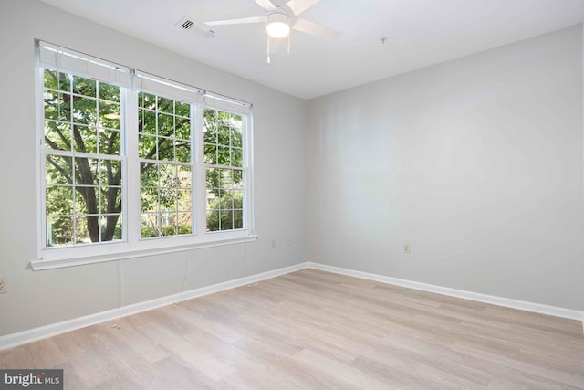unfurnished room featuring visible vents, baseboards, ceiling fan, and light wood-type flooring