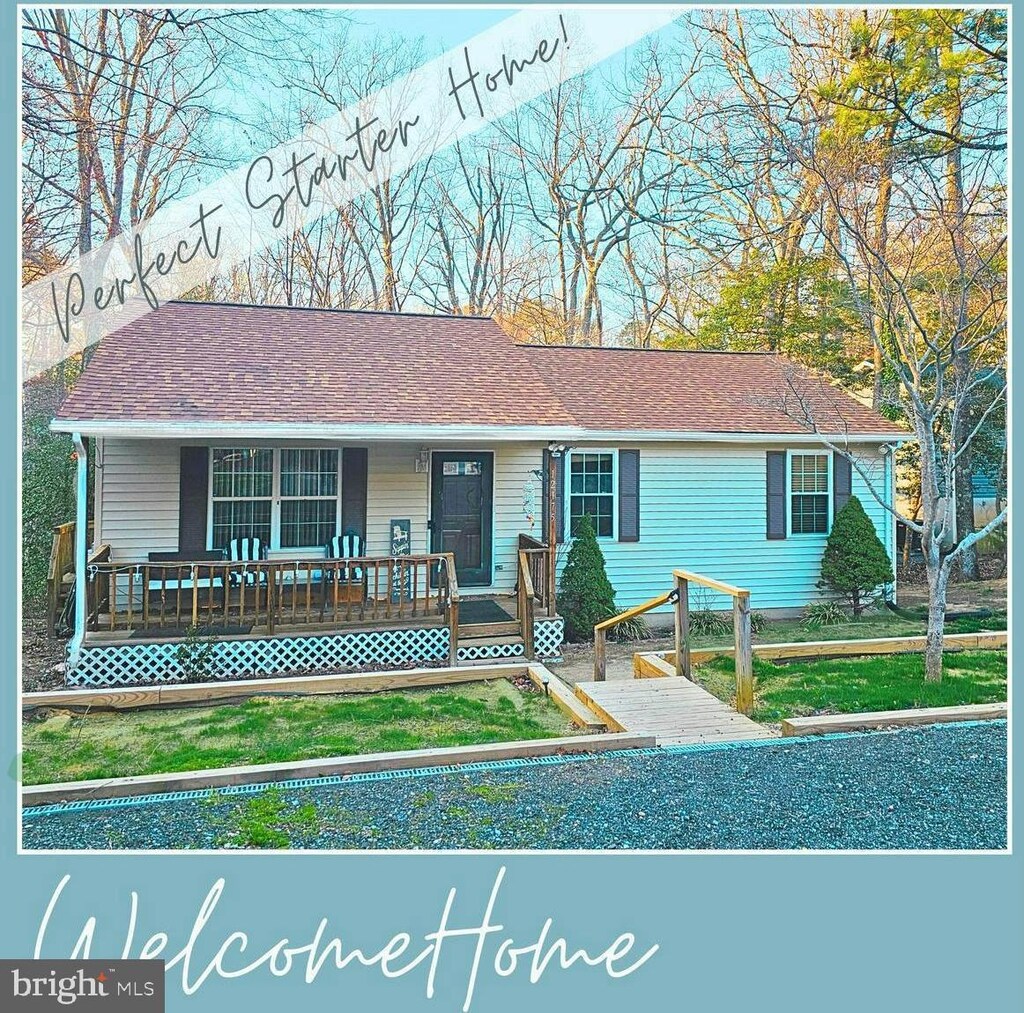 view of front of home with covered porch and a shingled roof