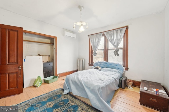 71 N 7th St, Easton, PA 18042 - bedroom featuring a wall unit AC, radiator, hardwood / wood-style floors, baseboards, and a chandelier