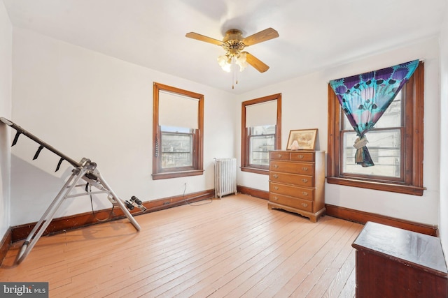 71 N 7th St, Easton, PA 18042 - unfurnished room with stairway, baseboards, ceiling fan, radiator heating unit, and light wood-style flooring
