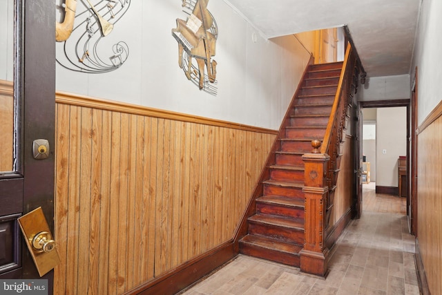 71 N 7th St, Easton, PA 18042 - stairway with a wainscoted wall, wood finished floors, and wood walls