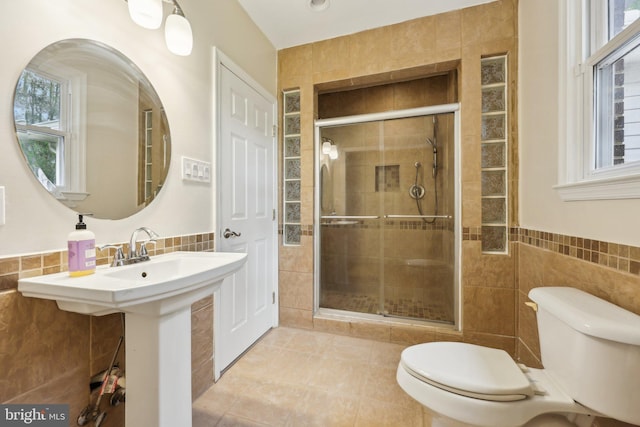 9532 Sherwood Dr, Upper Marlboro, MD 20772 - bathroom with tile walls, a stall shower, and toilet