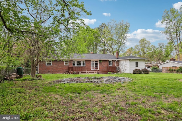 9532 Sherwood Dr, Upper Marlboro, MD 20772 - back of property with a wooden deck, fence, a chimney, brick siding, and a lawn