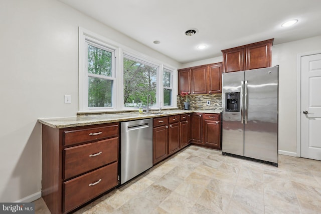 9532 Sherwood Dr, Upper Marlboro, MD 20772 - kitchen featuring appliances with stainless steel finishes, decorative backsplash, baseboards, and light stone counters