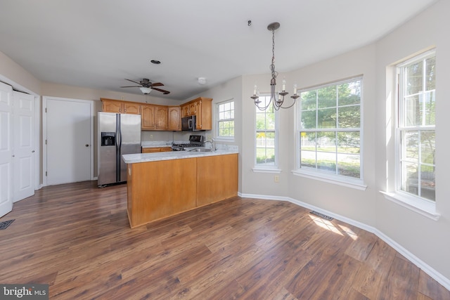 kitchen with dark wood-style flooring, range, light countertops, a sink, and stainless steel fridge