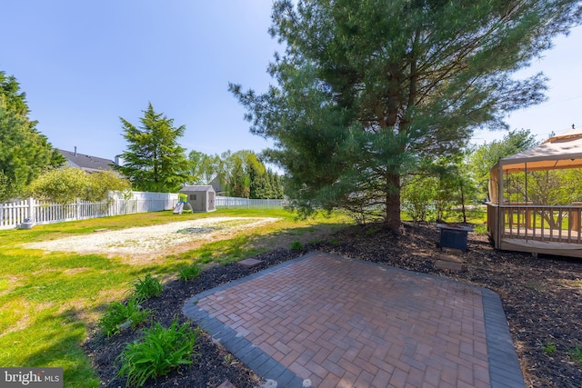 view of patio with an outdoor structure, a gazebo, a shed, and a fenced backyard