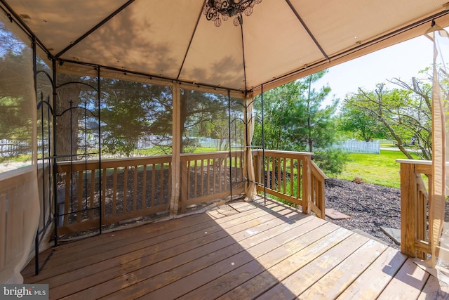 deck featuring a gazebo, fence, and a yard