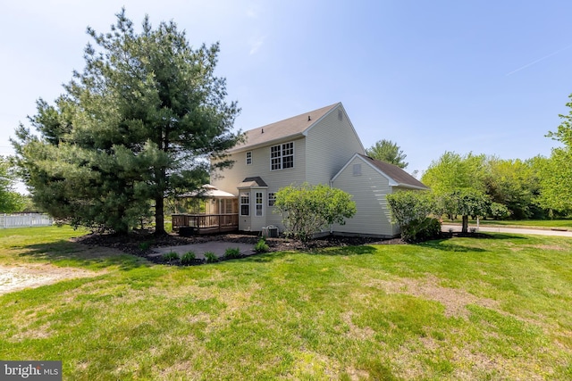 view of side of home with a yard and a deck