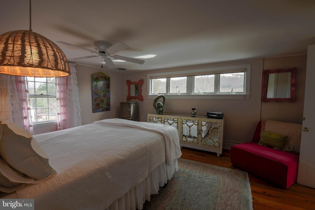 bedroom with a ceiling fan and wood finished floors
