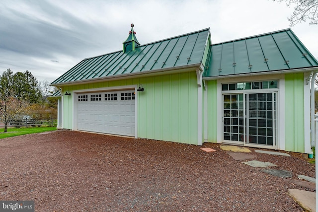 view of property exterior with dirt driveway, metal roof, and a standing seam roof
