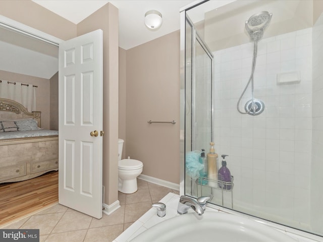 353 Fallsgrove Dr Unit 51, Rockville, MD 20850 - ensuite bathroom with a tile shower, toilet, baseboards, tile patterned floors, and ensuite bath