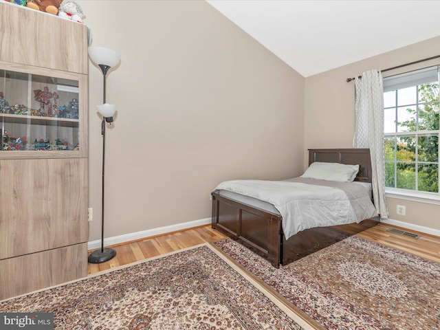 353 Fallsgrove Dr Unit 51, Rockville, MD 20850 - bedroom with wood finished floors, baseboards, vaulted ceiling, and visible vents