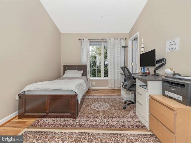 353 Fallsgrove Dr Unit 51, Rockville, MD 20850 - bedroom with baseboards, vaulted ceiling, and light wood-type flooring