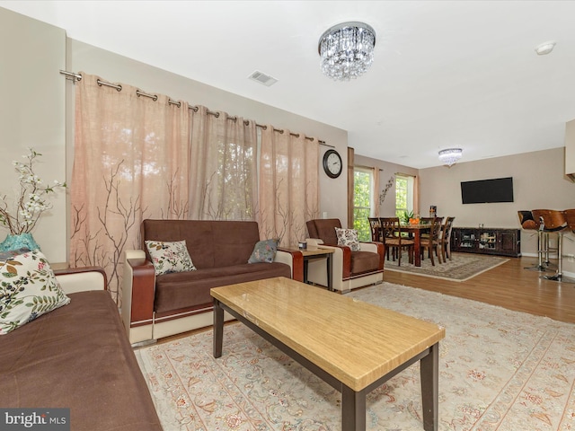 353 Fallsgrove Dr Unit 51, Rockville, MD 20850 - living room featuring visible vents, a notable chandelier, and wood finished floors