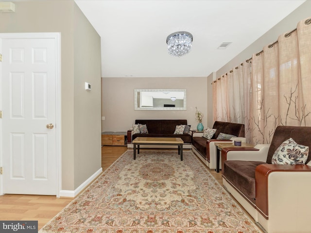353 Fallsgrove Dr Unit 51, Rockville, MD 20850 - living room featuring baseboards, visible vents, light wood-type flooring, and an inviting chandelier