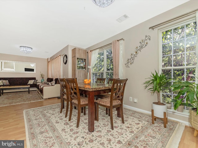 353 Fallsgrove Dr Unit 51, Rockville, MD 20850 - dining area with baseboards, visible vents, an inviting chandelier, and light wood-type flooring