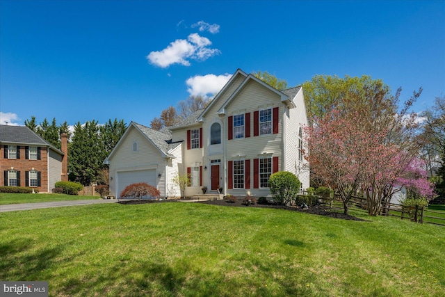 view of front of home with fence, driveway, and a front yard