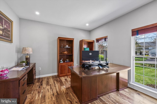 office area with recessed lighting, a wealth of natural light, wood finished floors, and baseboards