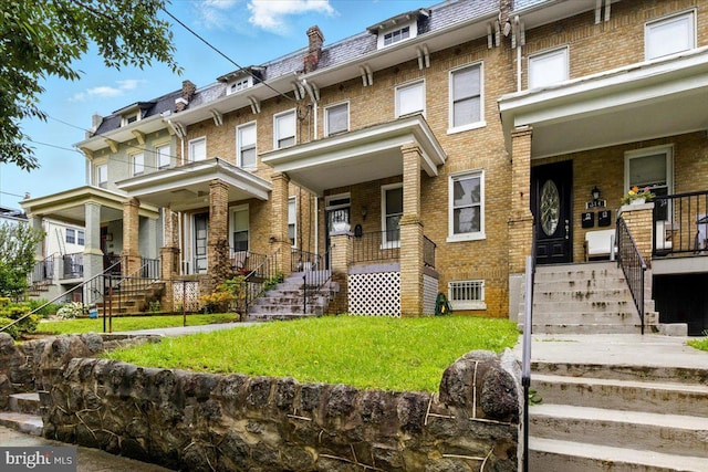 312 Webster St NW, Washington, DC 20011 - multi unit property featuring covered porch, stairs, mansard roof, and brick siding