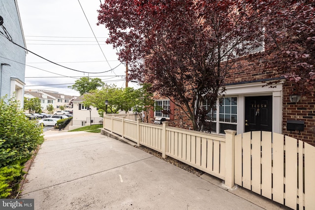 1465 N Van Dorn St, Alexandria, VA 22304 - view of property exterior featuring brick siding and a fenced front yard