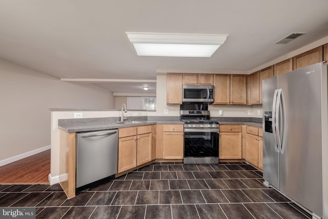 1465 N Van Dorn St, Alexandria, VA 22304 - kitchen with a sink, light brown cabinetry, visible vents, a peninsula, and appliances with stainless steel finishes