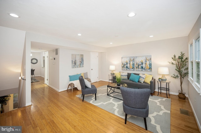 living area with recessed lighting, light wood-style floors, baseboards, and visible vents