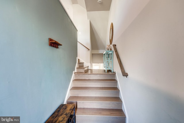 staircase with wood finished floors