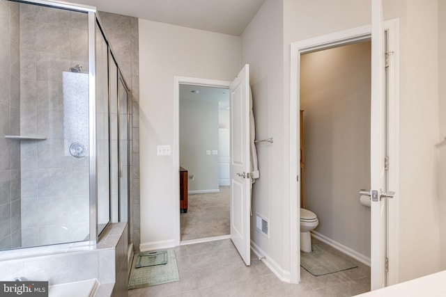 bathroom with tile patterned flooring, toilet, baseboards, a shower stall, and visible vents
