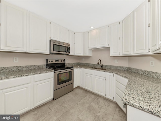 6093 Baldridge Ct, Frederick, MD 21701 - kitchen with appliances with stainless steel finishes, a sink, white cabinets, recessed lighting, and light stone countertops