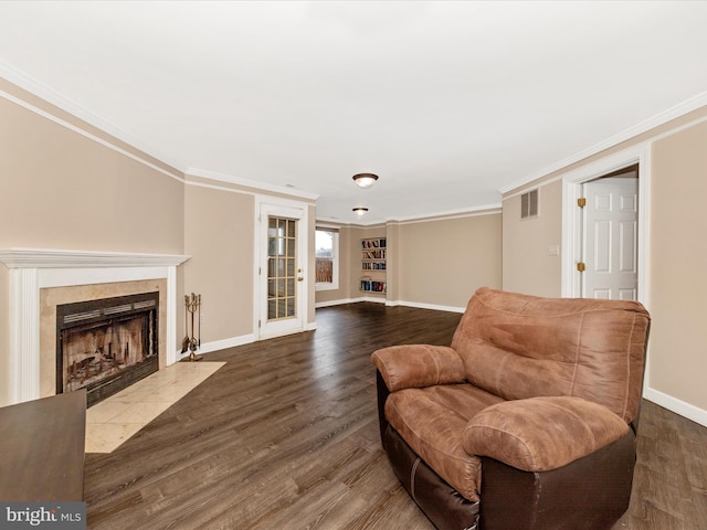 6093 Baldridge Ct, Frederick, MD 21701 - sitting room featuring baseboards, dark wood finished floors, a tiled fireplace, and ornamental molding