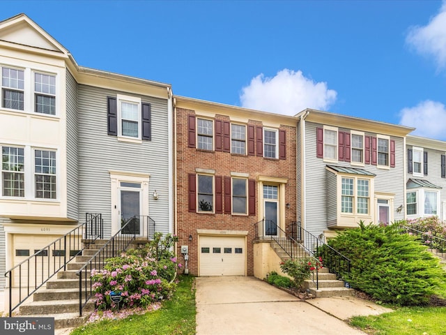 6093 Baldridge Ct, Frederick, MD 21701 - townhome / multi-family property with a garage, concrete driveway, and brick siding