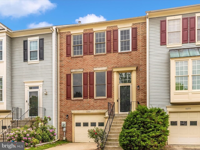 6093 Baldridge Ct, Frederick, MD 21701 - view of property featuring an attached garage, driveway, and brick siding