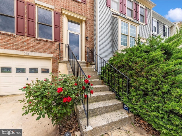 6093 Baldridge Ct, Frederick, MD 21701 - view of exterior entry featuring brick siding and a garage