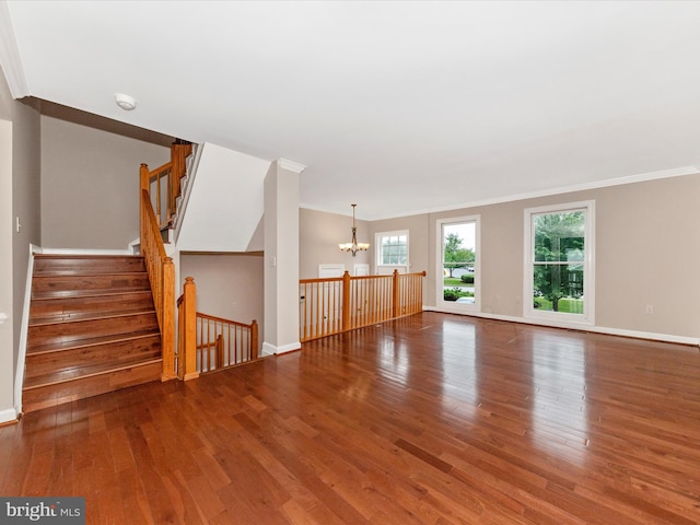 6093 Baldridge Ct, Frederick, MD 21701 - unfurnished living room featuring a chandelier, wood finished floors, ornamental molding, and baseboards