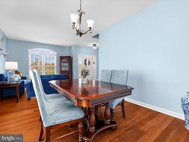 1121 Old Love Point Rd, Stevensville, MD 21666 - dining space featuring an inviting chandelier, wood finished floors, and baseboards