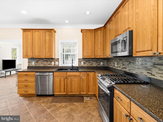 1121 Old Love Point Rd, Stevensville, MD 21666 - kitchen with ornamental molding, a sink, appliances with stainless steel finishes, and a healthy amount of sunlight