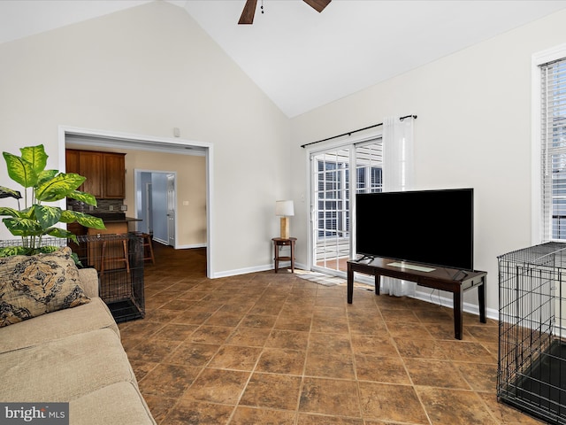 1121 Old Love Point Rd, Stevensville, MD 21666 - living area with high vaulted ceiling, baseboards, a ceiling fan, and a wealth of natural light
